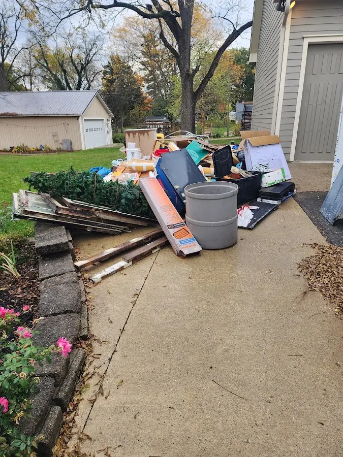 Dumpster being loaded with debris for Estate Cleanout Dumpster Rental in West University Place